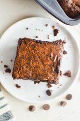 overhead photo of brownie on a white plate.