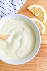 Overhead photo of aioli in a bowl on a cutting board.