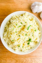 Overhead photo of garlic rice in a white bowl.