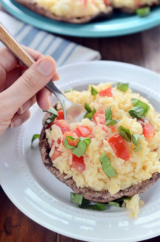 Garlic Rice Stuffed Portobello Mushrooms are stuffed with garlic rice, tomatoes and goat cheese then sprinkled with fresh basil. It is a hearty dish that is great as a side dish or a vegetarian main dish.