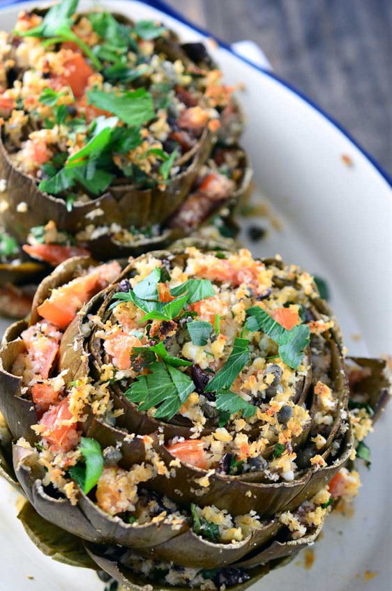 Artichokes loaded with kalamata olives, garlic, olive oil, parsley, oregano, bread crumbs, tomatoes, feta and capers make these Greek Stuffed Artichokes a gorgeous way to welcome spring!