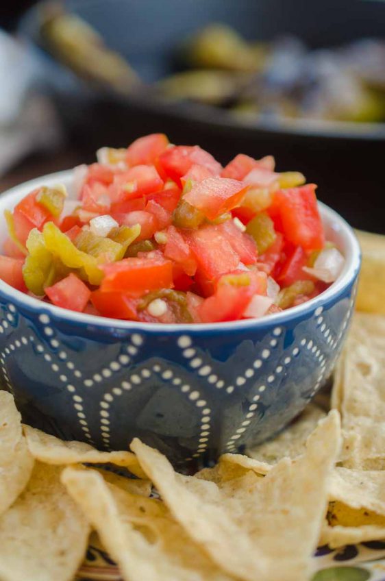 Hatch Chile Salsa Fresca is made with roasted hatch chilies, fresh tomatoes, onions, garlic and lime. It's a fun twist on fresh salsa!