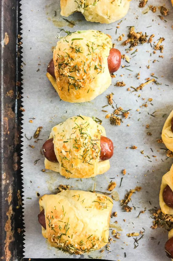 Mini Pigs in a blanket on a baking sheet.