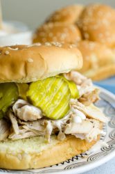 This easy pulled chicken sandwich is made with chicken marinated in Alabama BBQ sauce, grilled, shredded and topped with more Alabama BBQ and bread and butter pickles. The perfect summer sandwich!