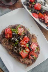 Ribeye steaks with fresh tomato tapenade are is the grilling recipe that you need this summer! Beefy goodness, topped with sweet summer tomatoes, it doesn't get much better.