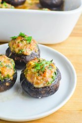 Sausage stuffed mushrooms on a white plate