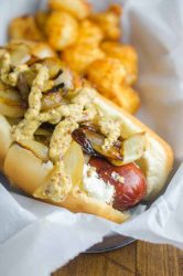 The Seattle Dog is Hot Dog Perfection. A perfectly cooked sausage slathered with cream cheese, and topped with caramelized onions and tangy mustard. 