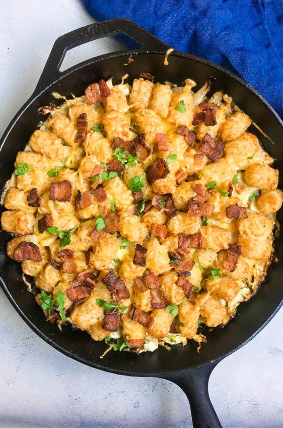 Kielbasa and Cabbage Tater Tot Casserole is comfort food of epic proportions. Sautéed cabbage and kielbasa topped with cheddar cheese and tater tots, then baked until crisp. 