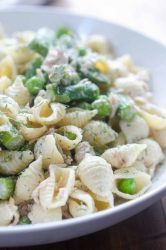 A spring take on Tuna Pasta Salad with peas and asparagus in a creamy dill dressing.