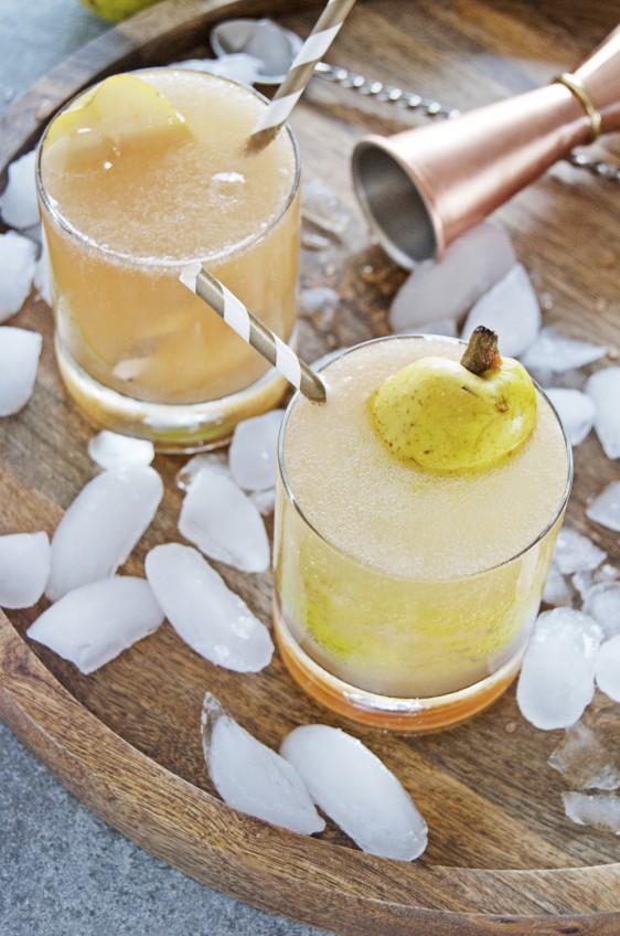 These cardamom pear spritzer cocktails feature delicious fresh pear juice, white rum, and a homemade honey cardamom simple syrup.