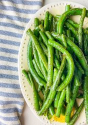 Dill Green Beans on an oval plate with a striped blue towel.