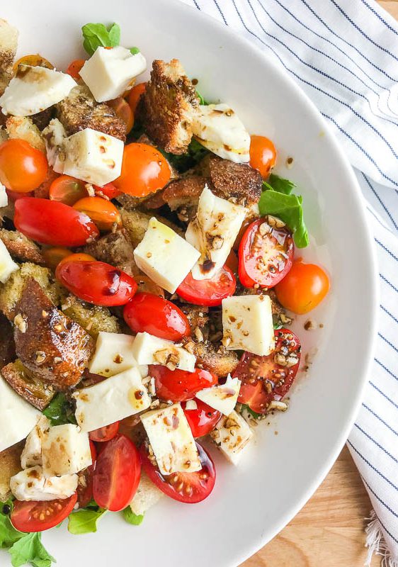 Panzanella Salad is a Tuscan salad with bread, tomatoes, herbs and a simple vinaigrette. It's the perfect way to enjoy summer tomatoes! 