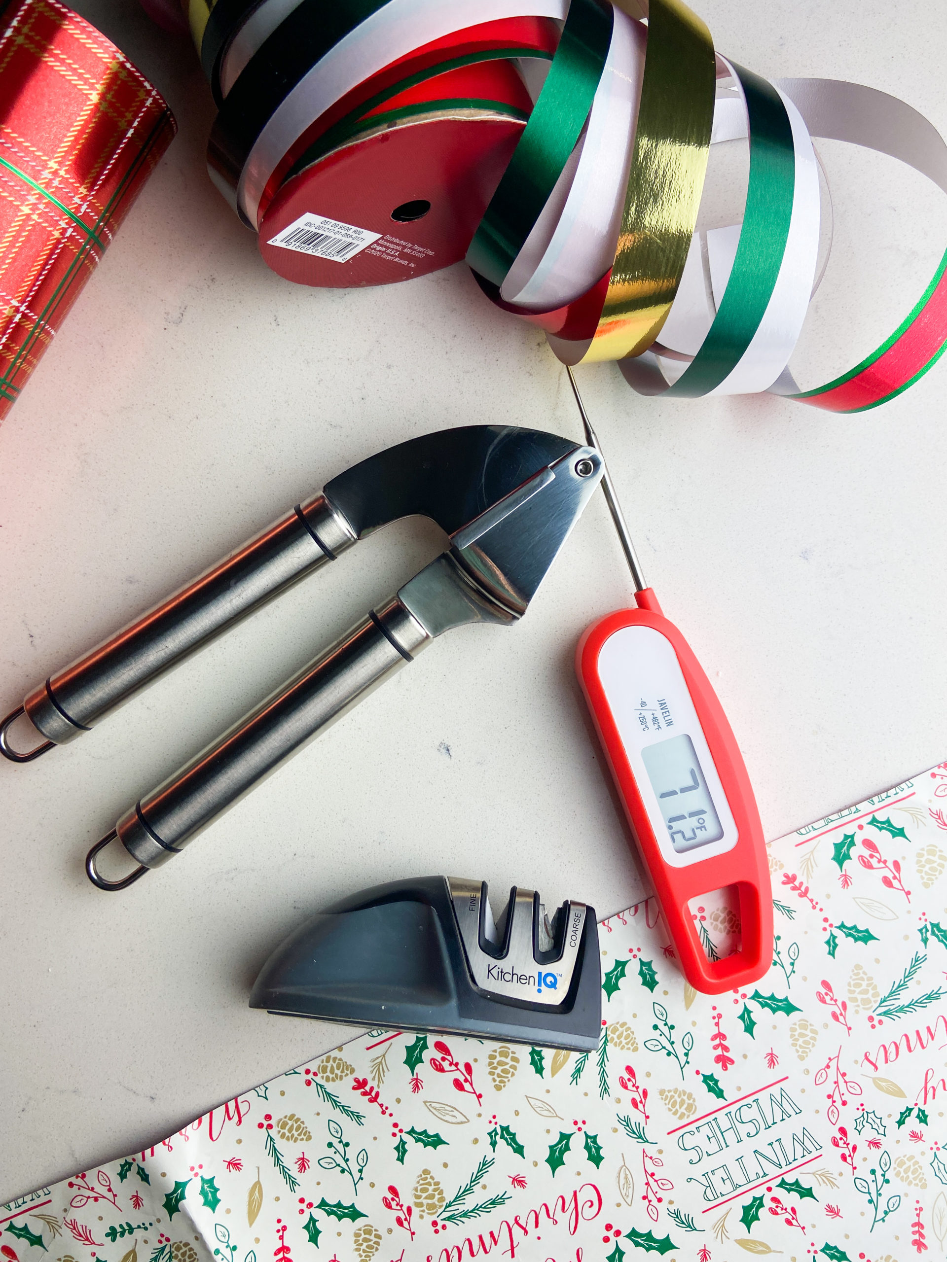 Garlic press, knife sharpener and digital meat thermometer. 