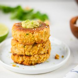 A stack of chickpea patties on white plate.