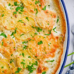 Easy scalloped potatoes in oval casserole dish.