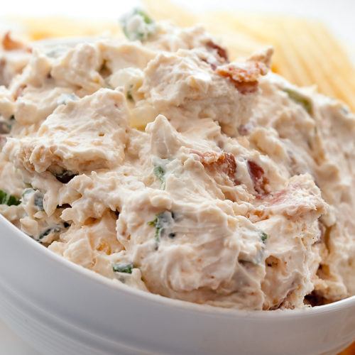 Bacon cheese dip in a white bowl.