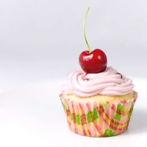 Single cupcake with a cherry on top.