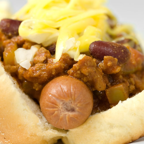 chili dog topped with onions and cheese