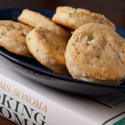 chive cream biscuit on black plate.