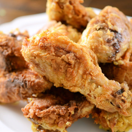 coconut curry fried chicken on white plate.