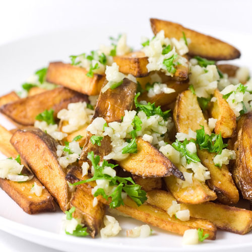 garlic fries on white plate.
