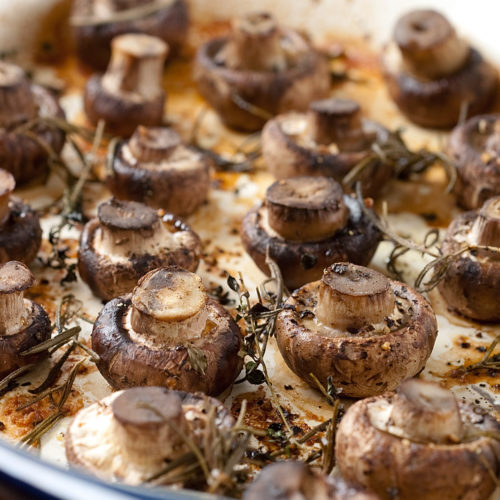 roasted mushrooms in baking dish.