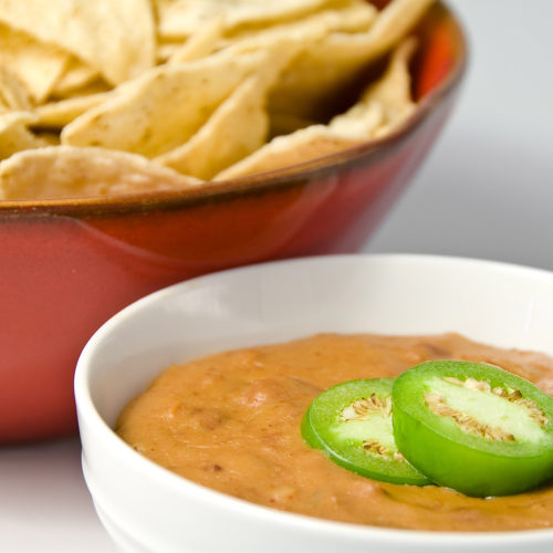 hot bean and cheese dip in white bowl