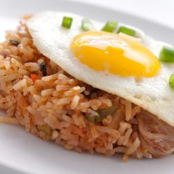 close up of kim chi fried rice with fried egg on top.