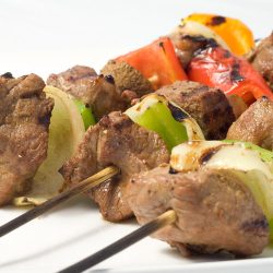 Marinated beef skewers on plate.