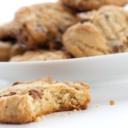 Peanut butter chocolate chip cookie with a bite out of it.