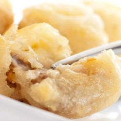 close up of fork cutting beer battered mushrooms