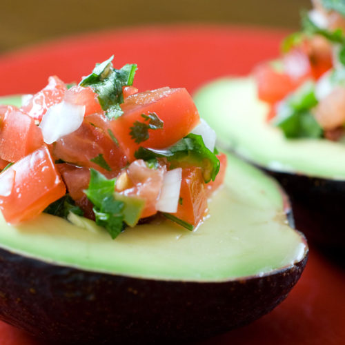 pico stuffed avocados on red plate.