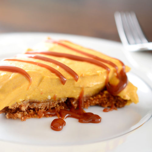 pumpkin cream pie on white plate