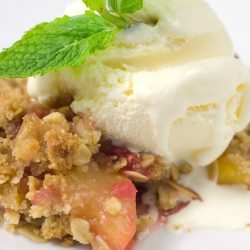 Raspberry peach crisp topped with ice cream.