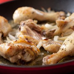 Roasted habanero chicken legs in a skillet.