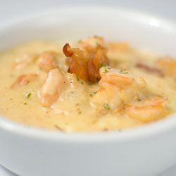 Shrimp and grits in white bowl.