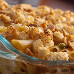 smoked cheddar and jalapeno mac and cheese in glass baking dish.