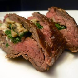 stuffed flank steak on white plate.