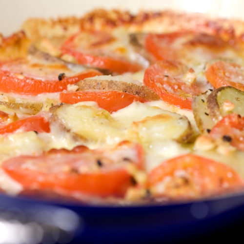 Tomato, potato, mozzarella bake in casserole dish.