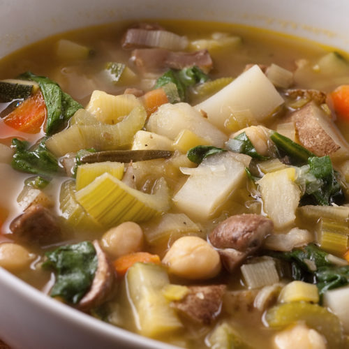 Vegetable soup in white bowl.