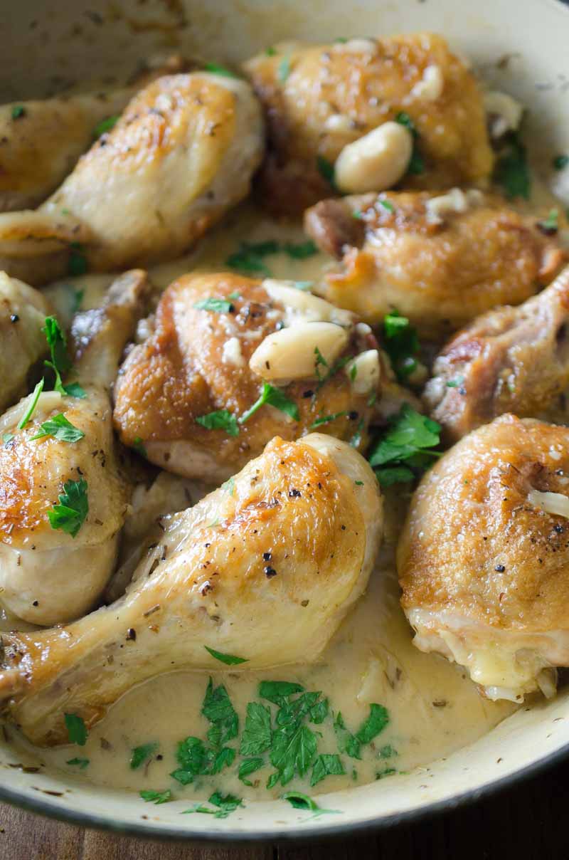 Chicken with 40 Cloves of Garlic is a baked chicken recipe, with 40 cloves of garlic, white wine, thyme, rosemary and a little cream. This easy dinner comes together in less than an hour!  Be still my heart.