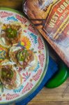 BBQ Pulled Pork Bruschetta is topped with goat cheese, Curly’s RoadTrip Eats West Coast IPA Style Pulled Pork, onions, jalapenos and BBQ sauce. It’s perfect for game day!