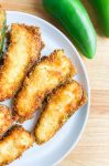 Fried Stuffed Jalapeno Poppers on a white plate.