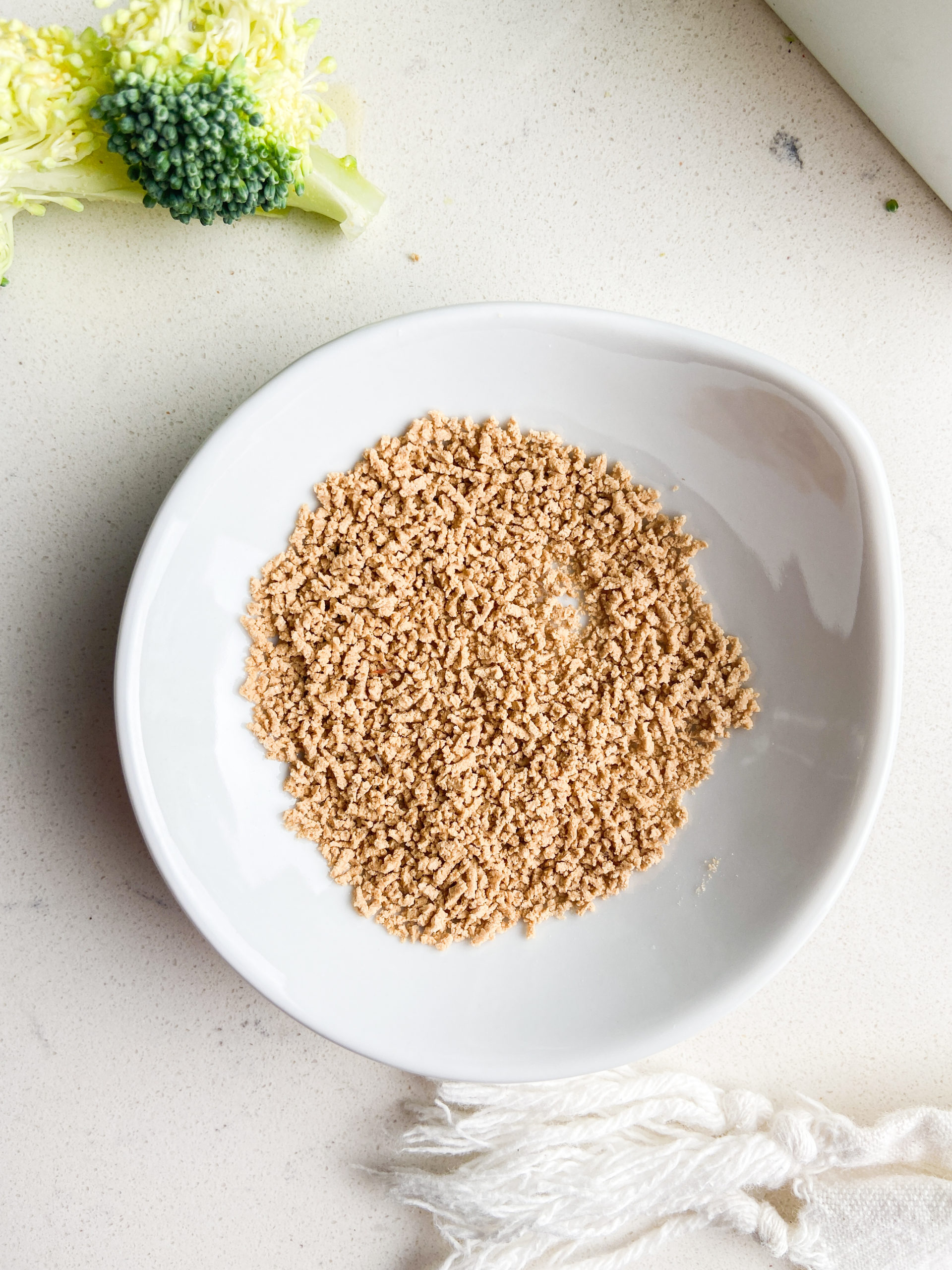 Overhead  photo of umami powder in a white bowl. 