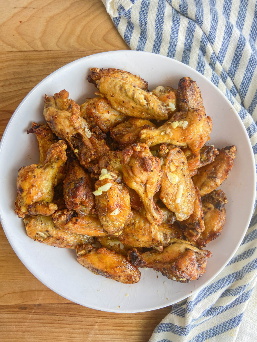 Overhead photo of air fryer chicken wings in a white bowl. 