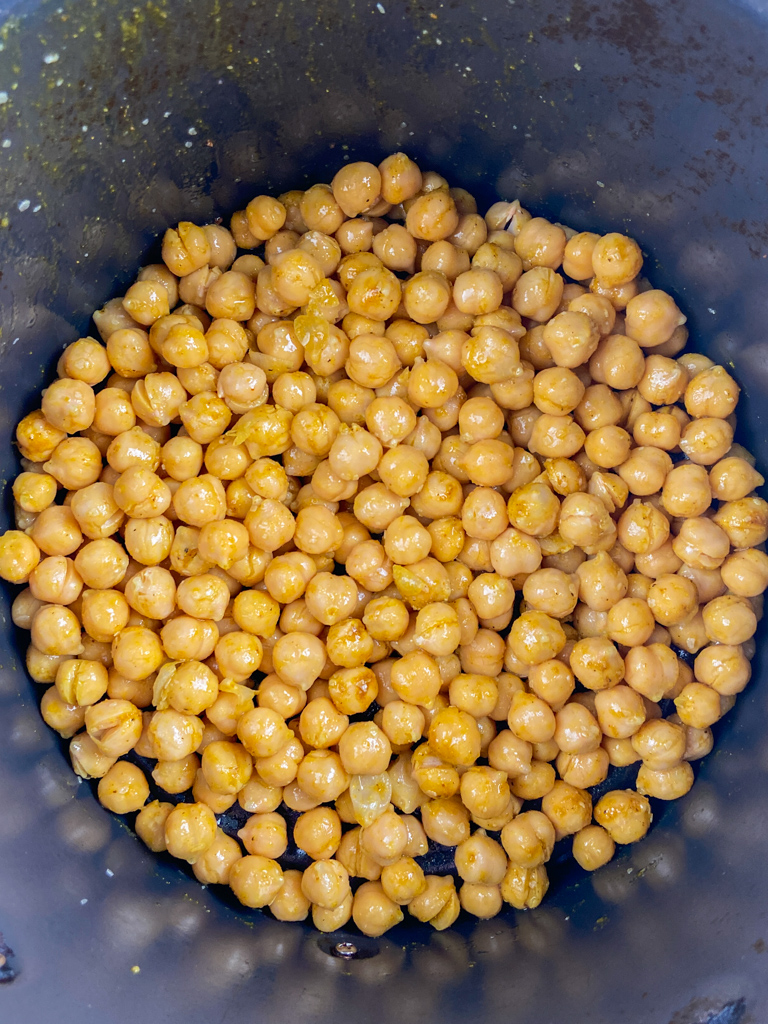 Chickpeas in an air fryer basket. 