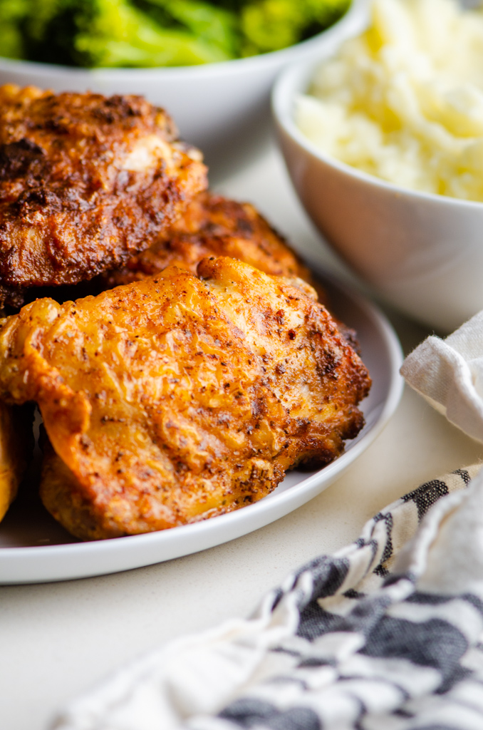 Crispy Chicken Thigh on white plate. 