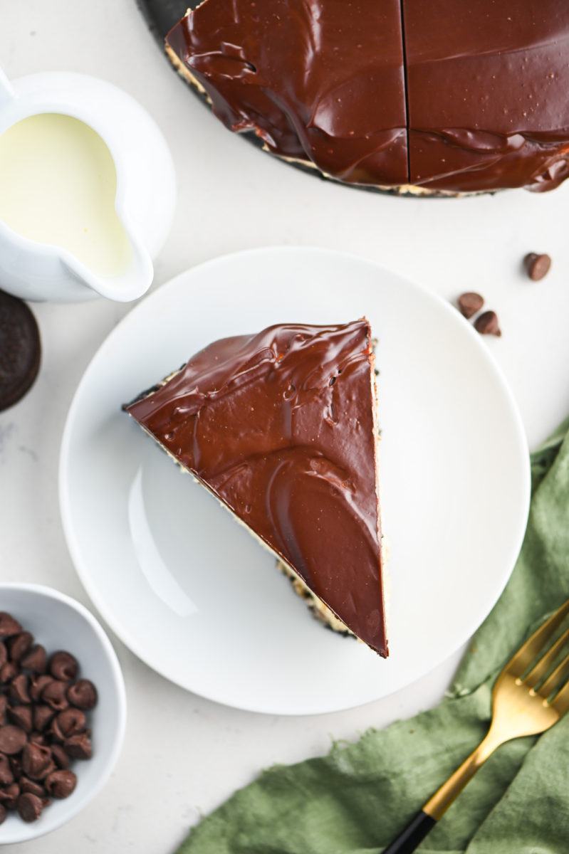 A slice of baileys cheesecake on a white plate. 