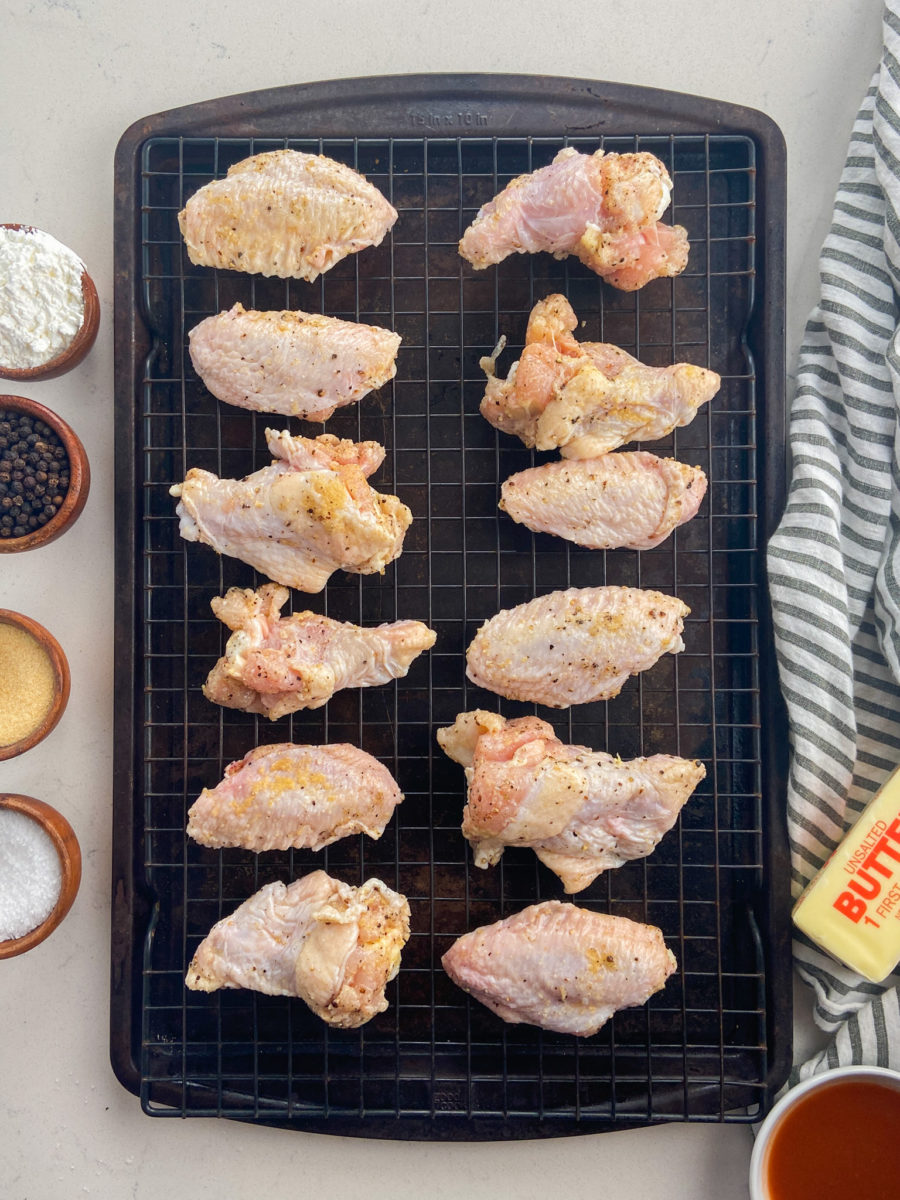 Chicken wings on a cooling rack on baking sheet. 