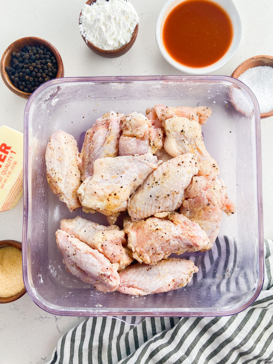 Raw chicken wings tossed in seasoning. 